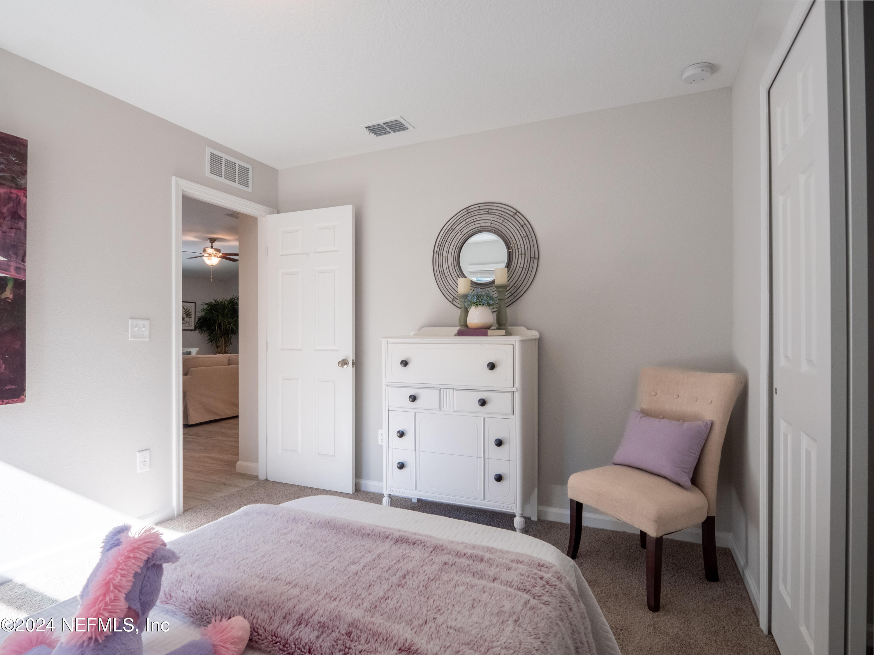 4011 Spring Glen Road Jacksonville, FL 32207 - Photo 33 of 38 a bedroom with a bed and a chair