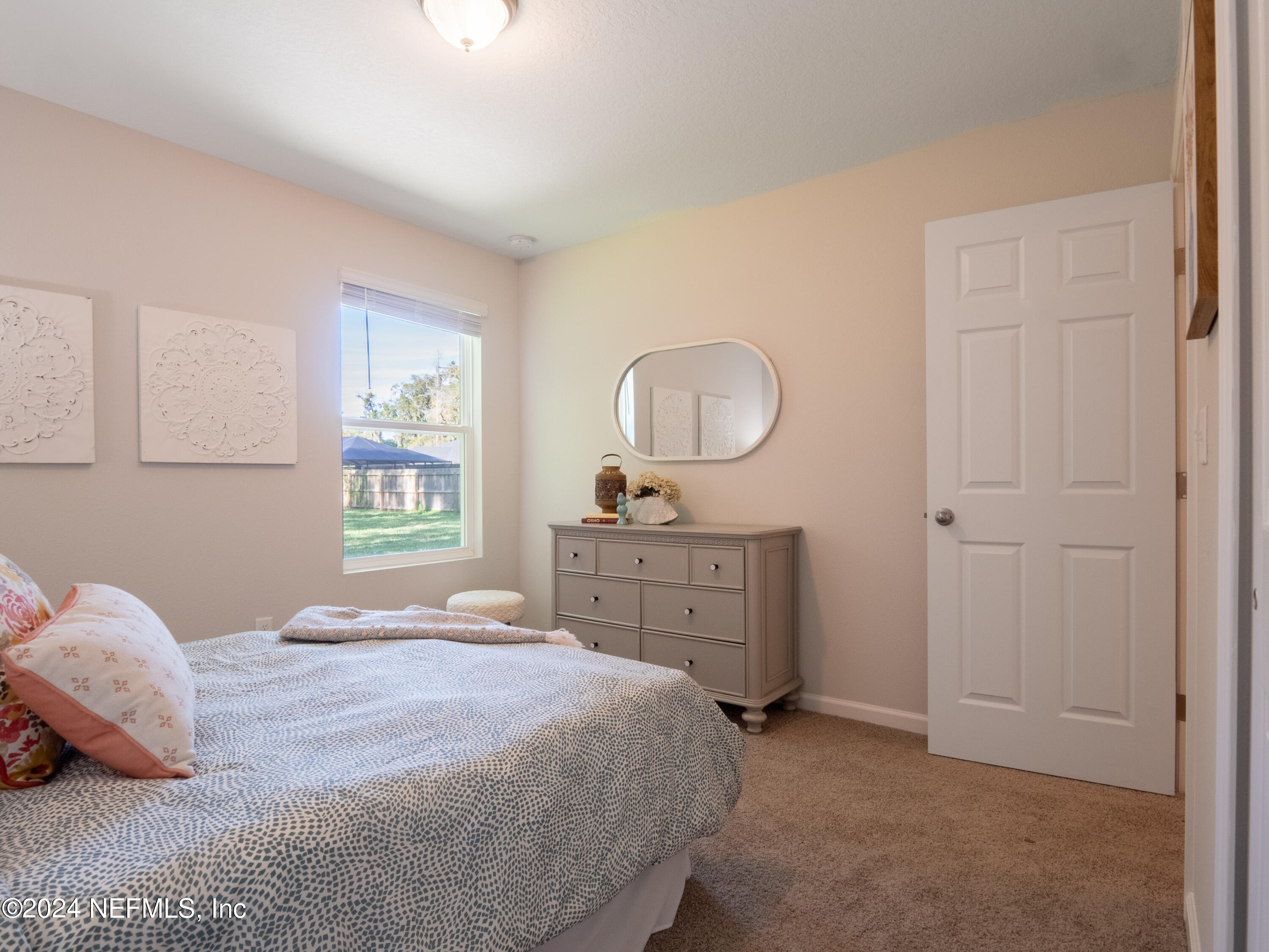 4011 Spring Glen Road Jacksonville, FL 32207 - Photo 36 of 38 a bedroom with a bed and a dresser