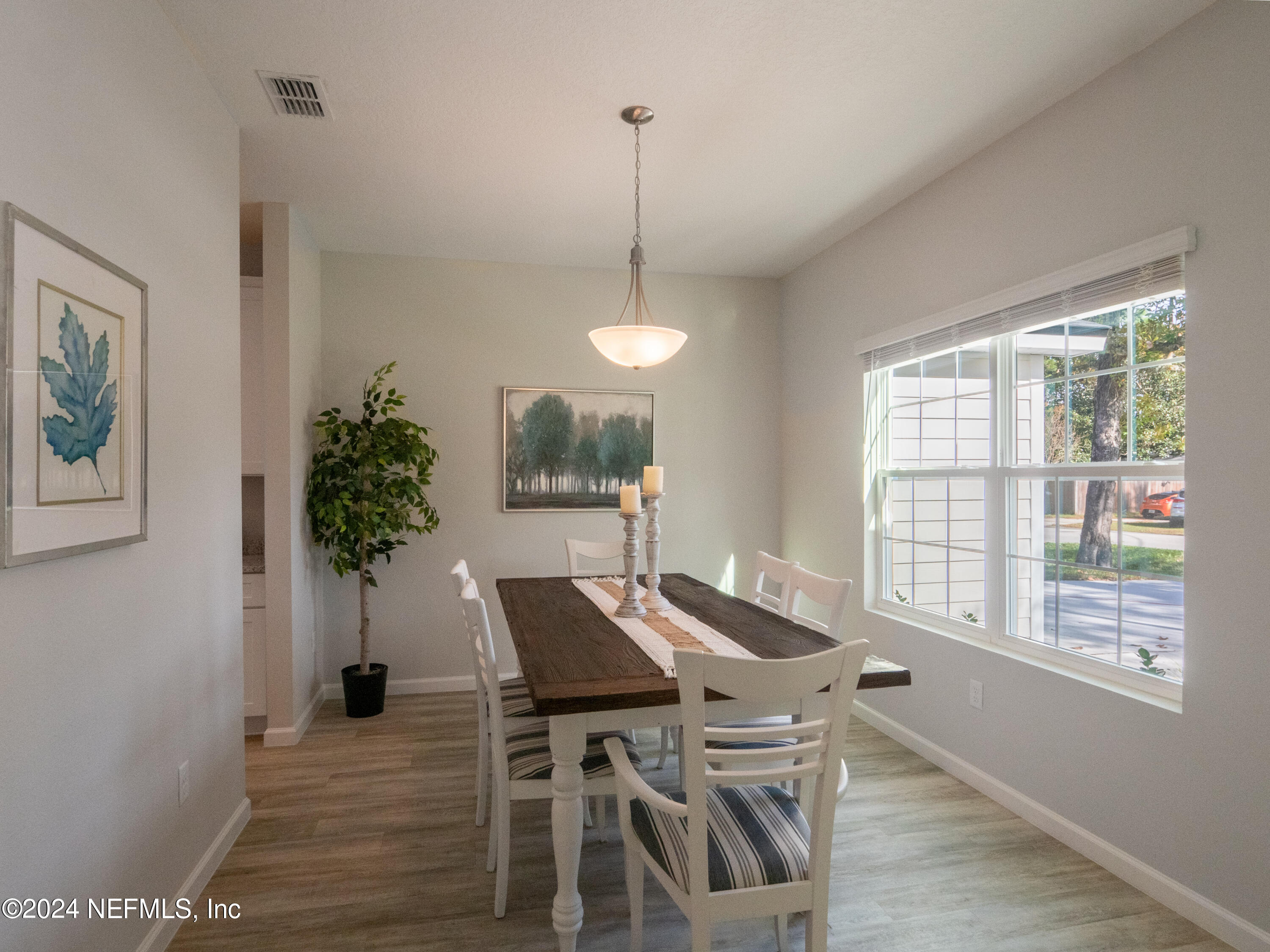 4011 Spring Glen Road Jacksonville, FL 32207 - Photo 9 of 38 a view of a dining room with furniture window and wooden floor