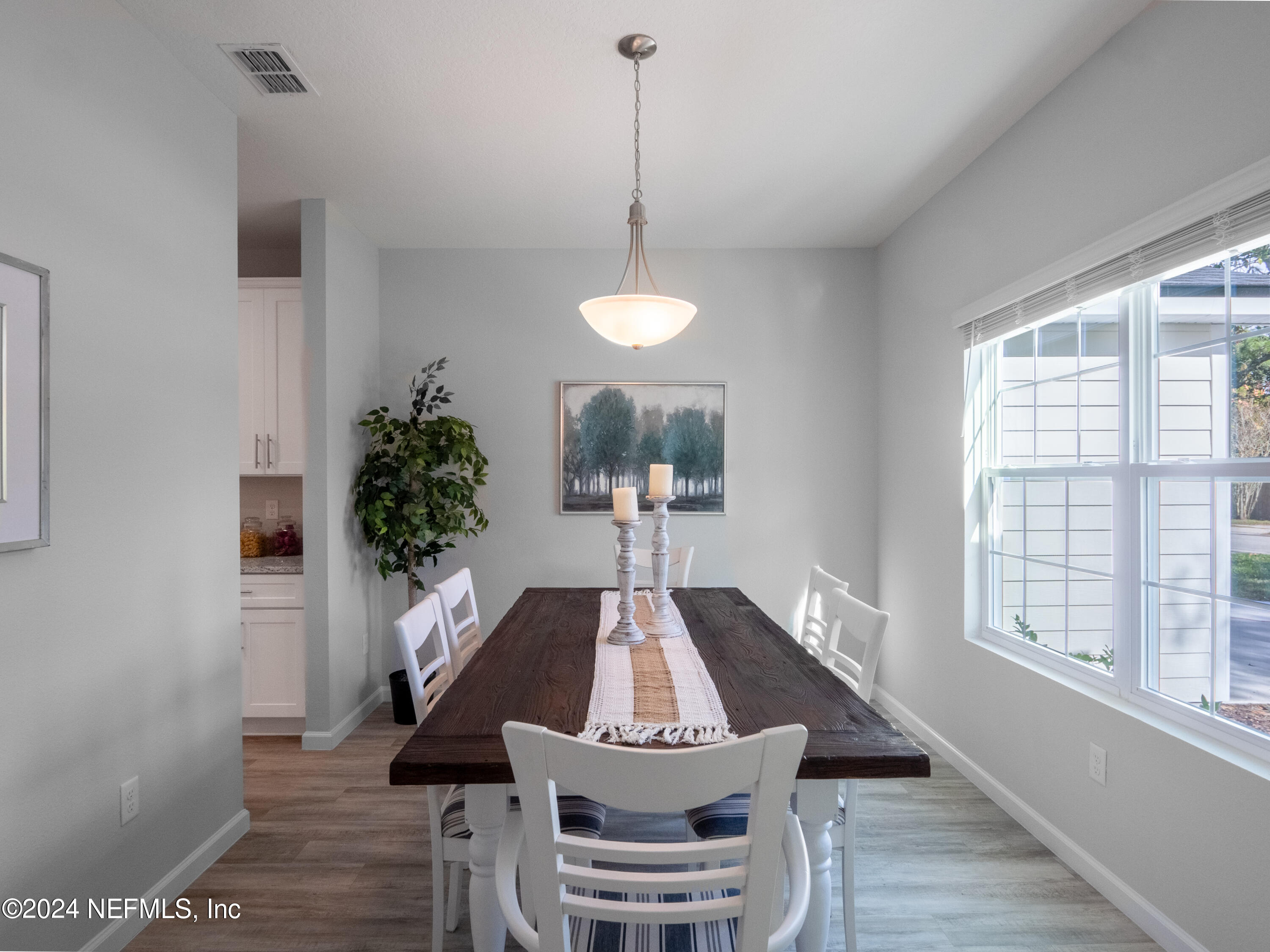 4011 Spring Glen Road Jacksonville, FL 32207 - Photo 10 of 38 a view of a dining room with furniture window and wooden floor