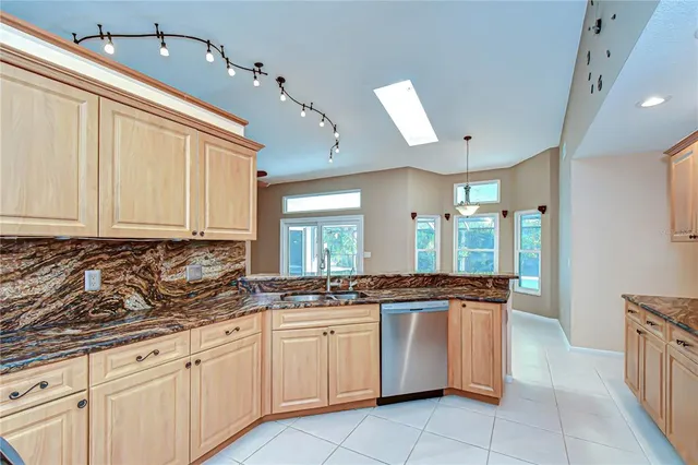 a view of a room with wooden floor fan and windows