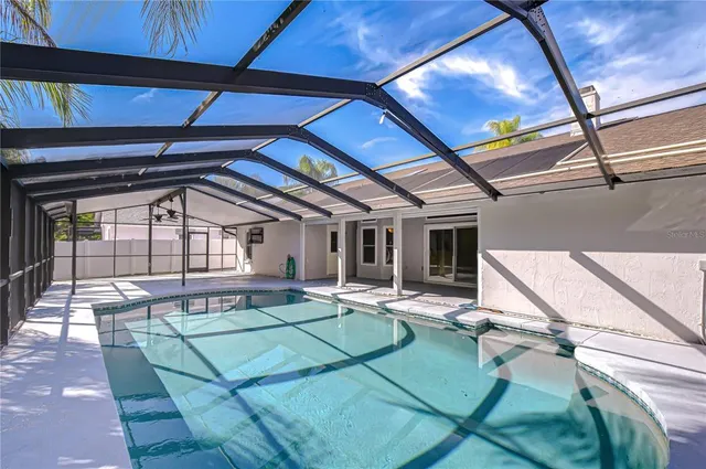 a living room with hardwood floor and ceiling fan