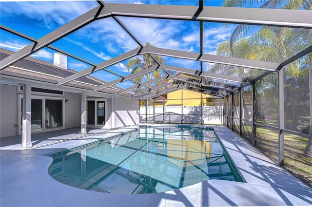 a view of swimming pool with outdoor seating and a garden