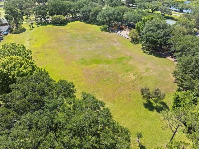 an aerial view of a house with a yard and lake view