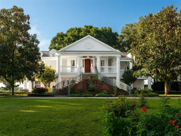 a front view of house with yard and green space