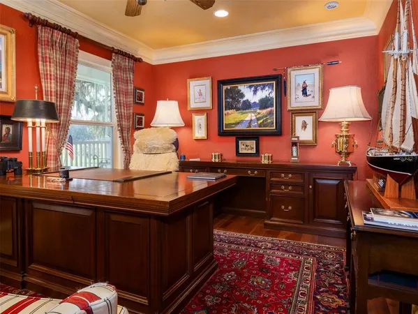 a living room with a table chairs and a dresser