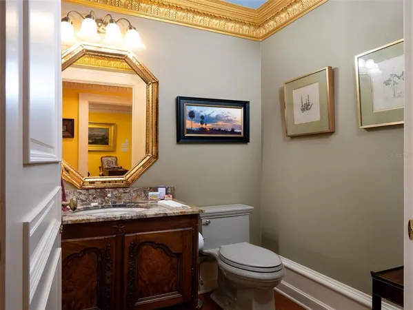 a bathroom with a toilet a sink and mirror