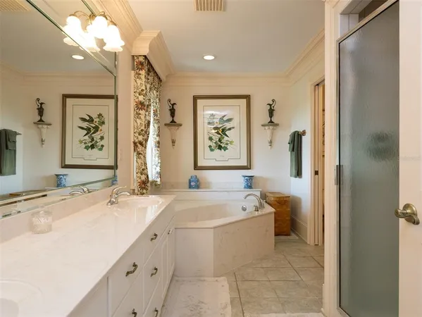 a spacious bathroom with a bathtub sink and mirror