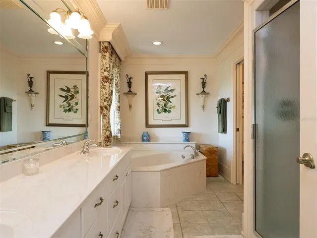 a spacious bathroom with a bathtub sink and mirror