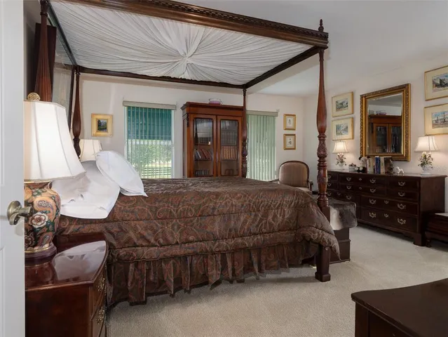 a bedroom with a bed window and couch