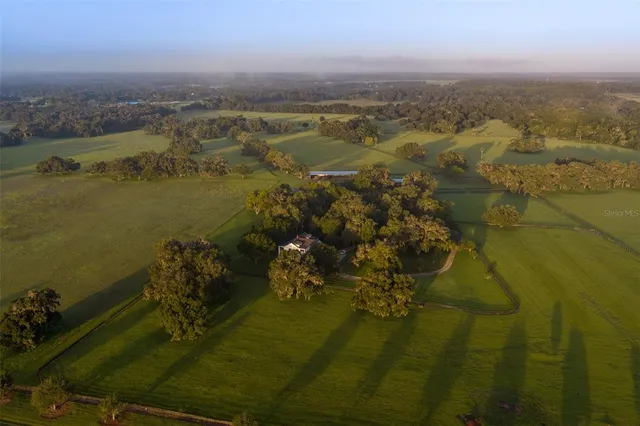an aerial view of ocean with residential houses with outdoor space