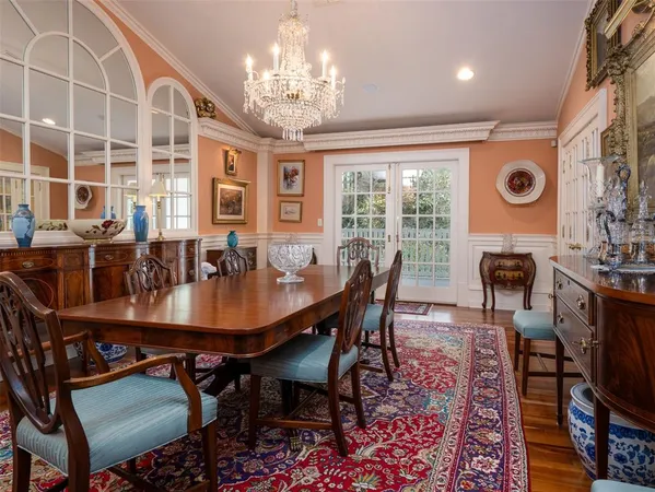 a view of a dining room with furniture a chandelier and wooden floor