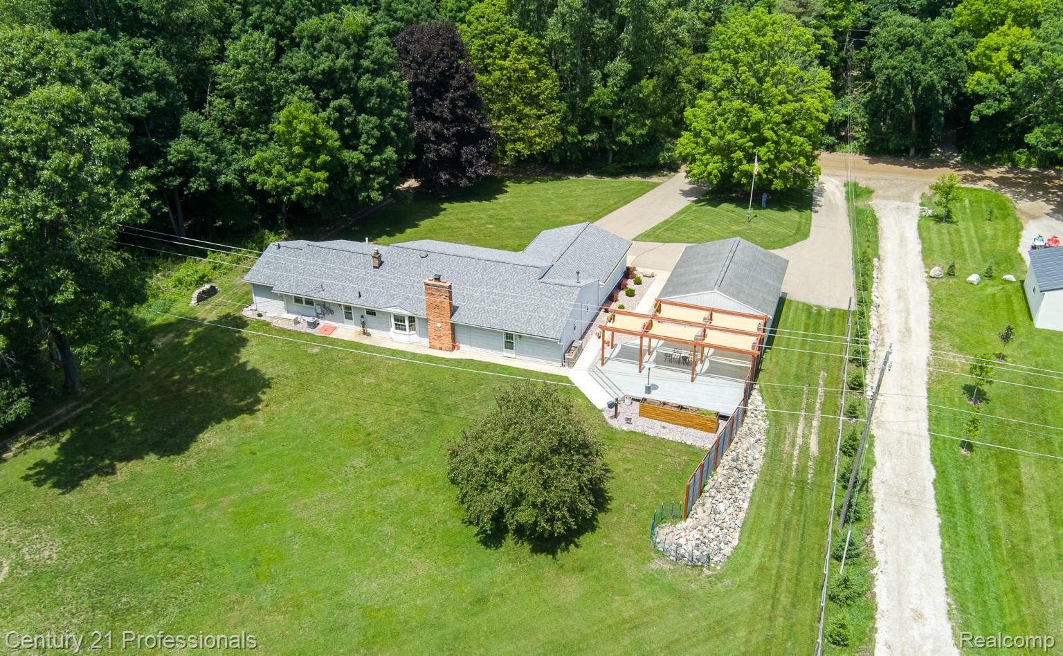 1790 Kent Road Ortonville, MI 48462 - Photo 62 of 64 Ranch-style residence featuring a gray shingle roof and a prominent brick chimney
