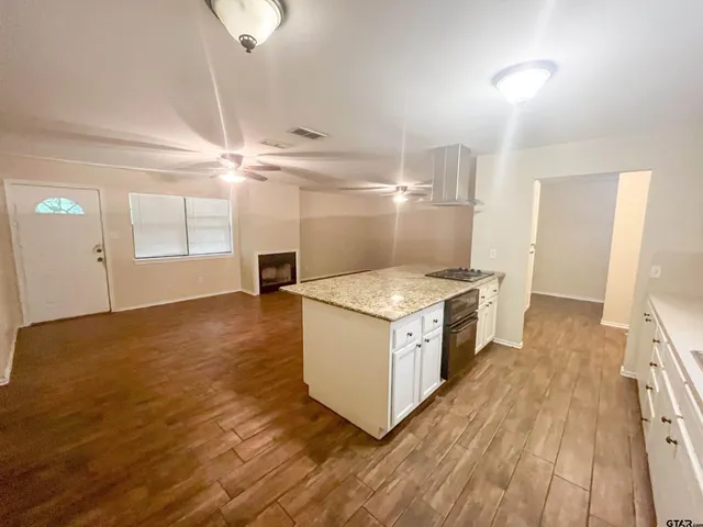 a kitchen with a sink and a stove top oven
