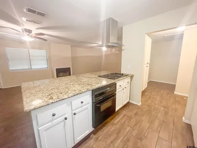 a kitchen with granite countertop white cabinets and white appliances