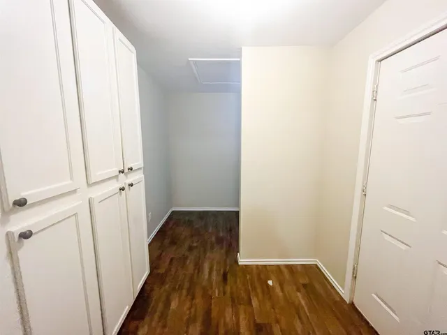 a view of a room with wooden floor and staircase