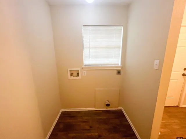 an empty room with a wooden door and a window