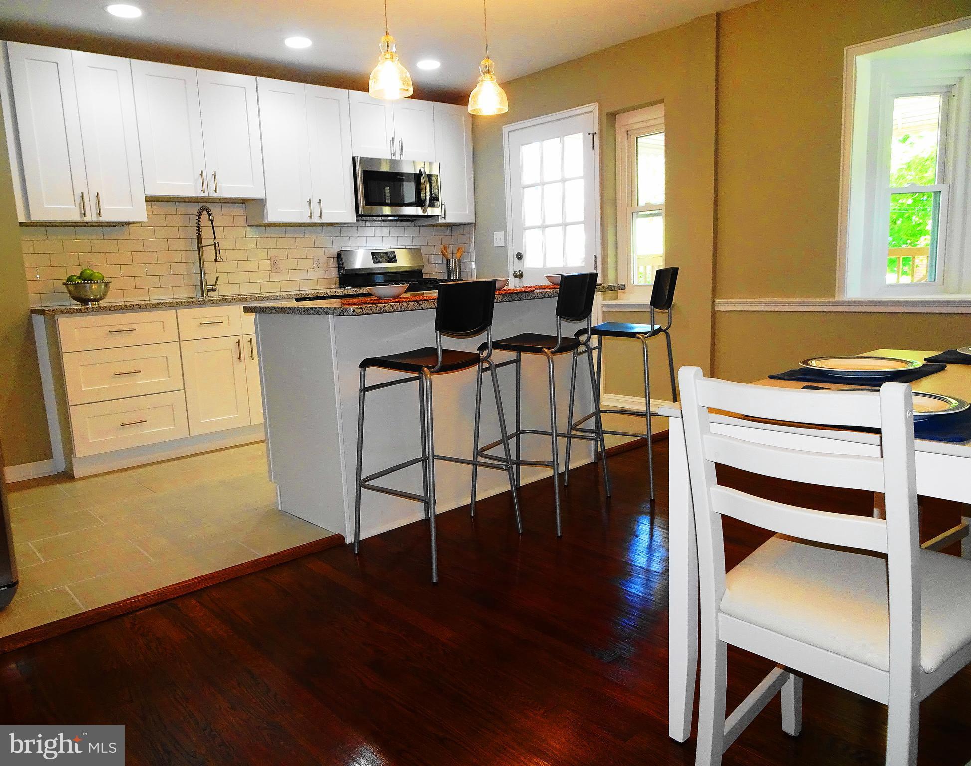 1732 Hartsdale Road Baltimore, MD 21239 - Photo 30 of 30 open floor plan kitchen / DR w/ hardwood floors