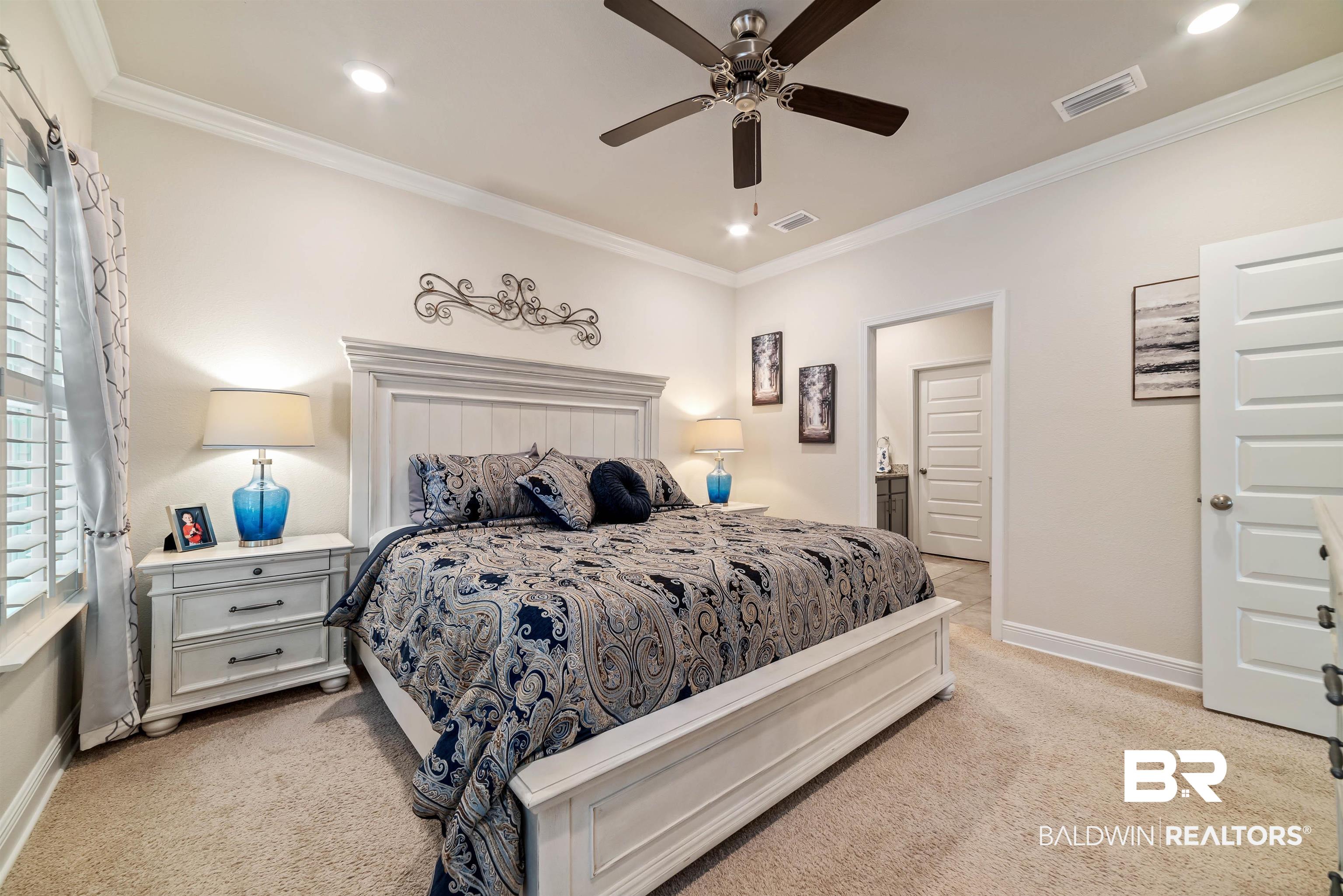 1290 Mako Loop Gulf Shores, AL 36542 - Photo 18 of 50 Bedroom featuring light carpet, baseboards, visible vents, and crown molding