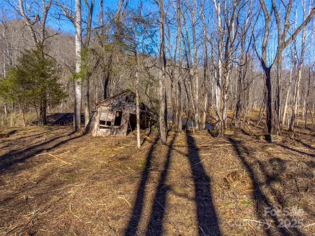 a view of a yard with wooden fence