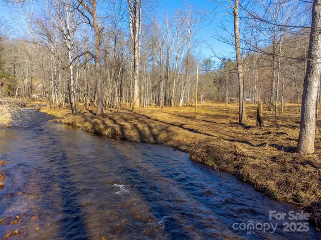 a view of a yard with wooden fence