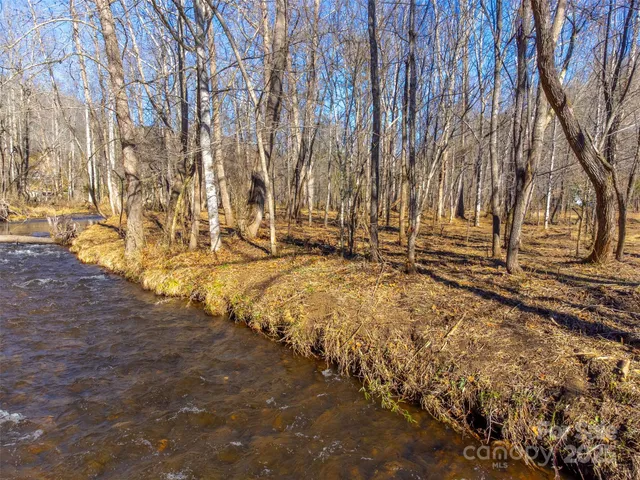a view of a yard with wooden fence