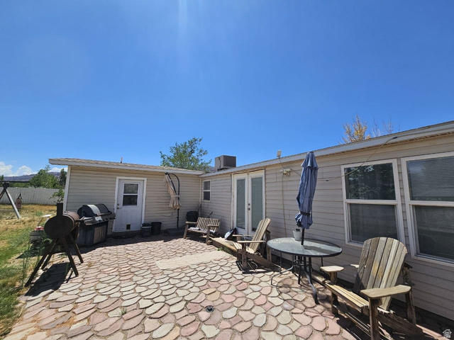 52 Quail Court Moab, UT 84532 - Photo 15 of 36 Patio area featuring an irregular stone paver surface, dual-pane windows, and a dedicated exterior door