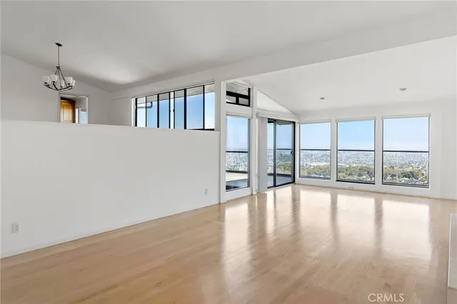 a view of a balcony with wooden floor and fence