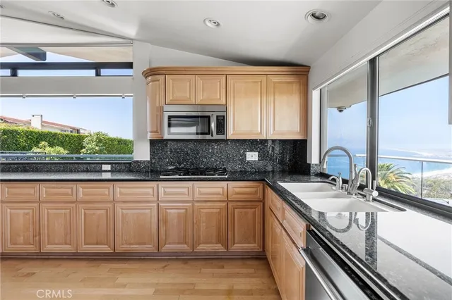 a large white kitchen with a large window