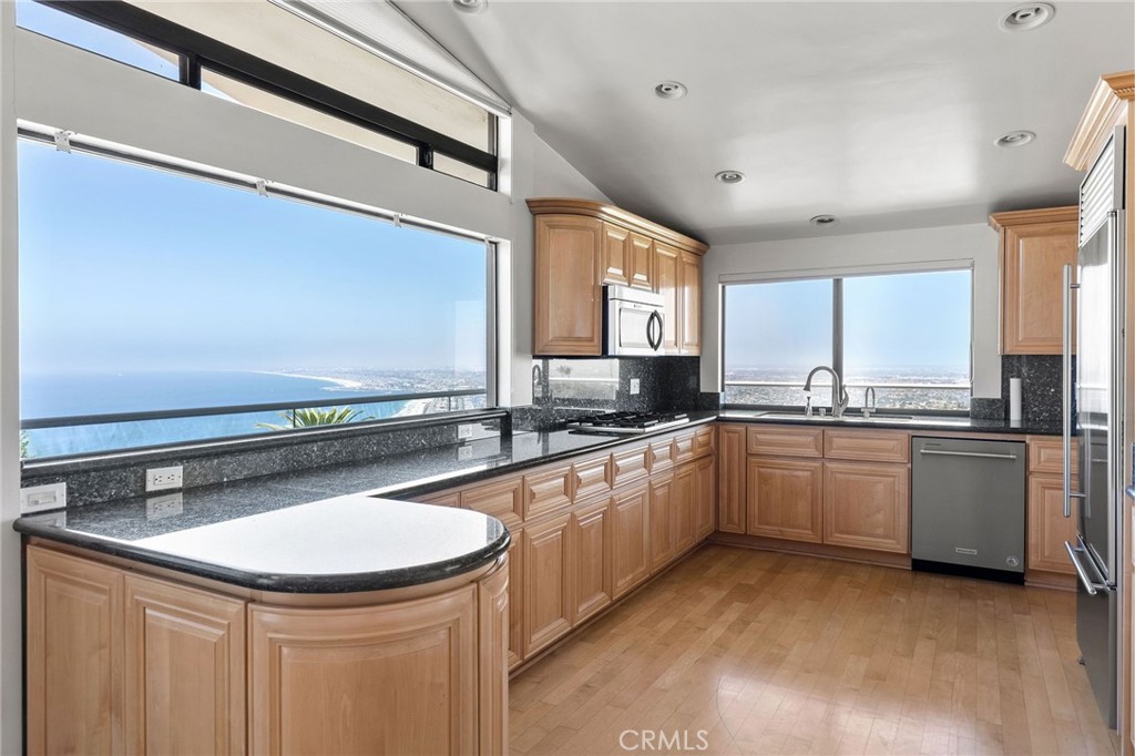 972 Via Rincon Palos Verdes Estates, CA 90274 - Photo 7 of 37 a kitchen with granite countertop a sink stainless steel appliances a window and a counter top space