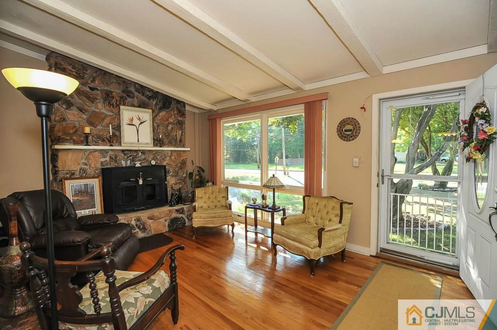 36 Middlesex Road Matawan, NJ 07747 - Photo 1 of 14 a living room with furniture a window and a fireplace