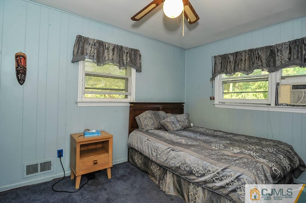 36 Middlesex Road Matawan, NJ 07747 - Photo 11 of 14 a bedroom with a bed and a chandelier