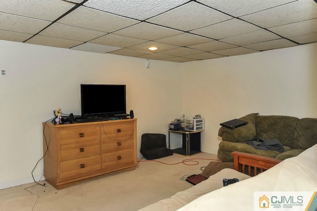 36 Middlesex Road Matawan, NJ 07747 - Photo 12 of 14 a living room with furniture and a flat screen tv