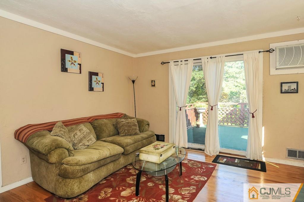 36 Middlesex Road Matawan, NJ 07747 - Photo 8 of 14 a living room with furniture and a floor to ceiling window