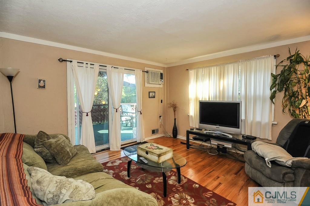 36 Middlesex Road Matawan, NJ 07747 - Photo 9 of 14 a living room with furniture and a flat screen tv