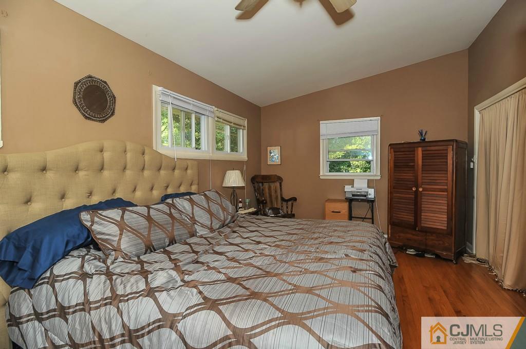 36 Middlesex Road Matawan, NJ 07747 - Photo 10 of 14 a bedroom with a bed and a cabinets