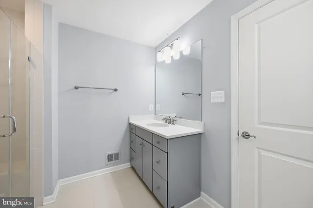 a bathroom with a sink a mirror and a shower