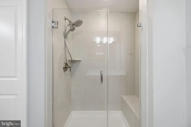 a bathroom with a glass shower door