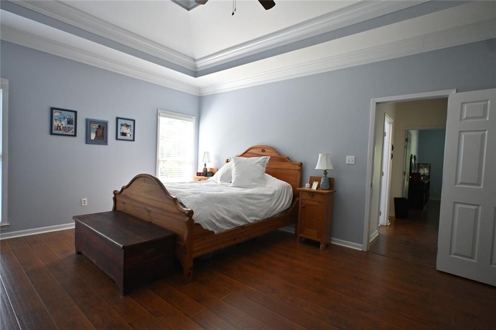 4865 Settles Point Road Suwanee, GA 30024 - Photo 12 of 25 a bedroom with a bed and a couch