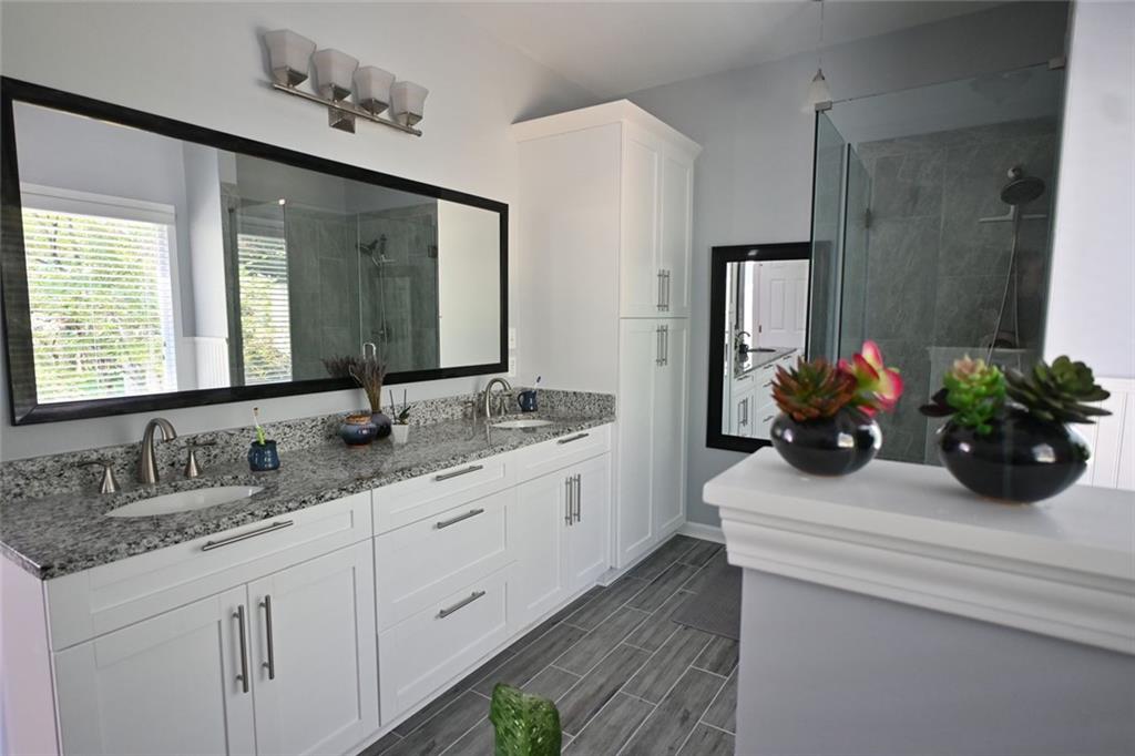 4865 Settles Point Road Suwanee, GA 30024 - Photo 15 of 25 a bathroom with a double vanity sink mirror and