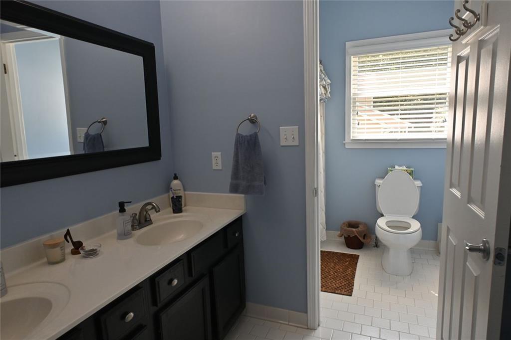4865 Settles Point Road Suwanee, GA 30024 - Photo 16 of 25 a bathroom with a sink vanity and a toilet