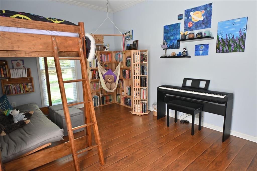 4865 Settles Point Road Suwanee, GA 30024 - Photo 17 of 25 a view of a workspace with furniture and wooden floor