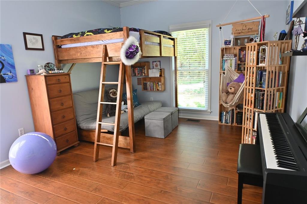 4865 Settles Point Road Suwanee, GA 30024 - Photo 18 of 25 a room with furniture and a floor to ceiling window