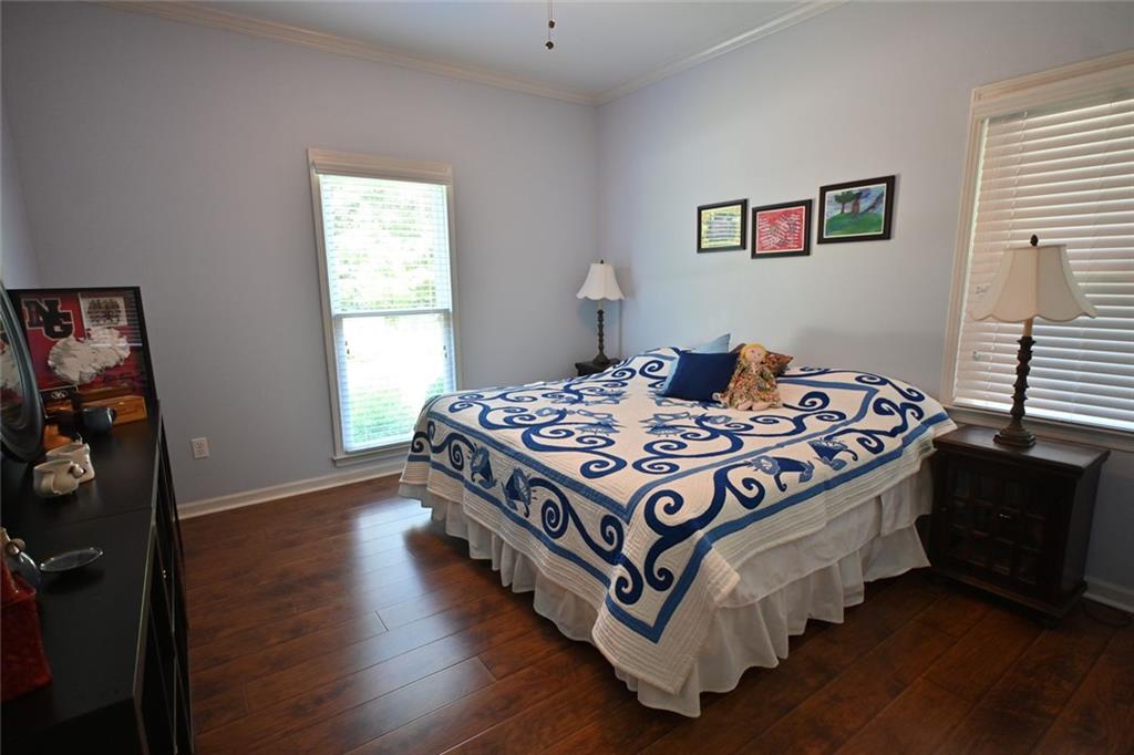 4865 Settles Point Road Suwanee, GA 30024 - Photo 19 of 25 a bedroom with a bed and a window