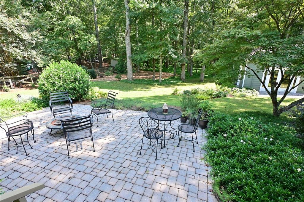 4865 Settles Point Road Suwanee, GA 30024 - Photo 20 of 25 a view of a chair and table in the garden