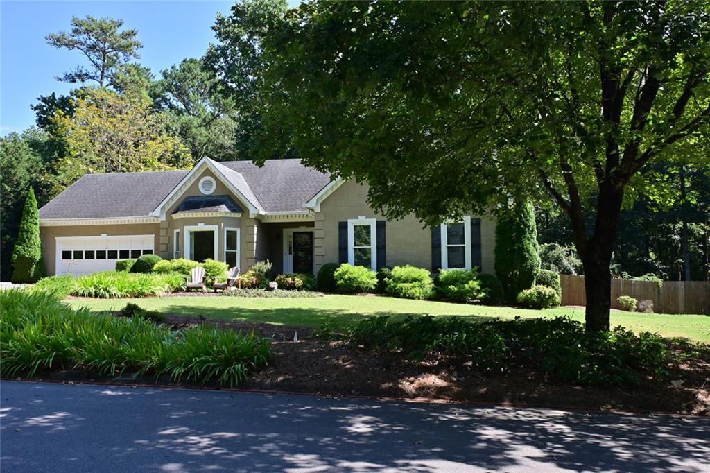 4865 Settles Point Road Suwanee, GA 30024 - Photo 2 of 25 a front view of a house with a yard