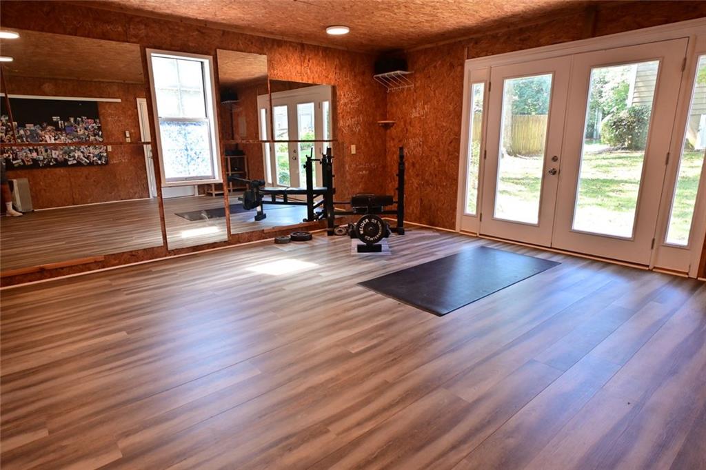 4865 Settles Point Road Suwanee, GA 30024 - Photo 21 of 25 a view of a room with wooden floor and furniture