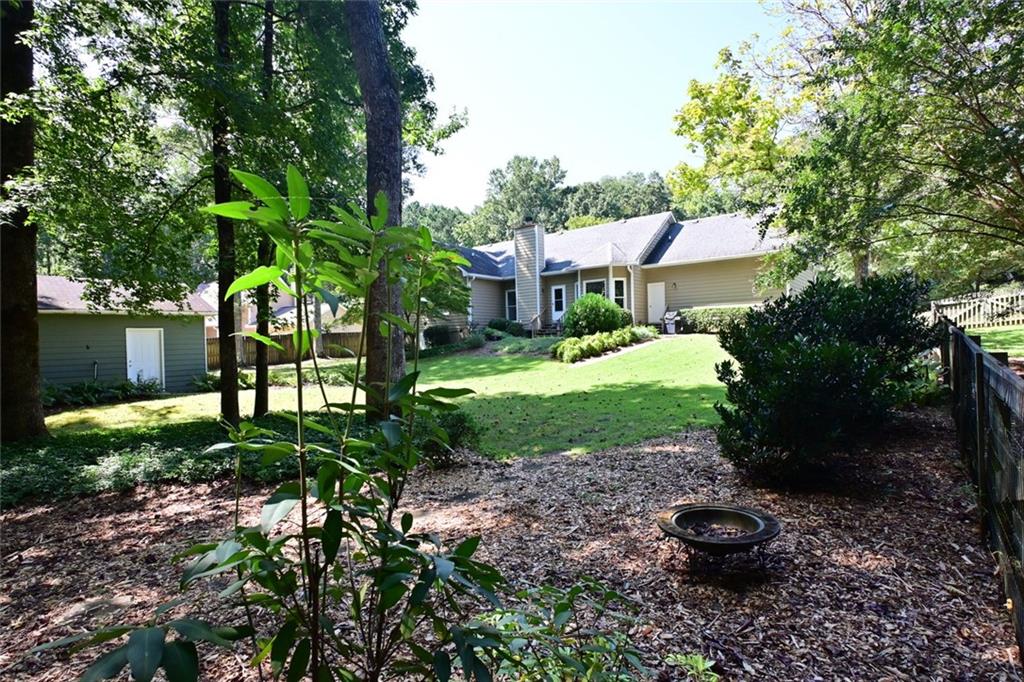 4865 Settles Point Road Suwanee, GA 30024 - Photo 24 of 25 a view of a backyard with plants and a garden