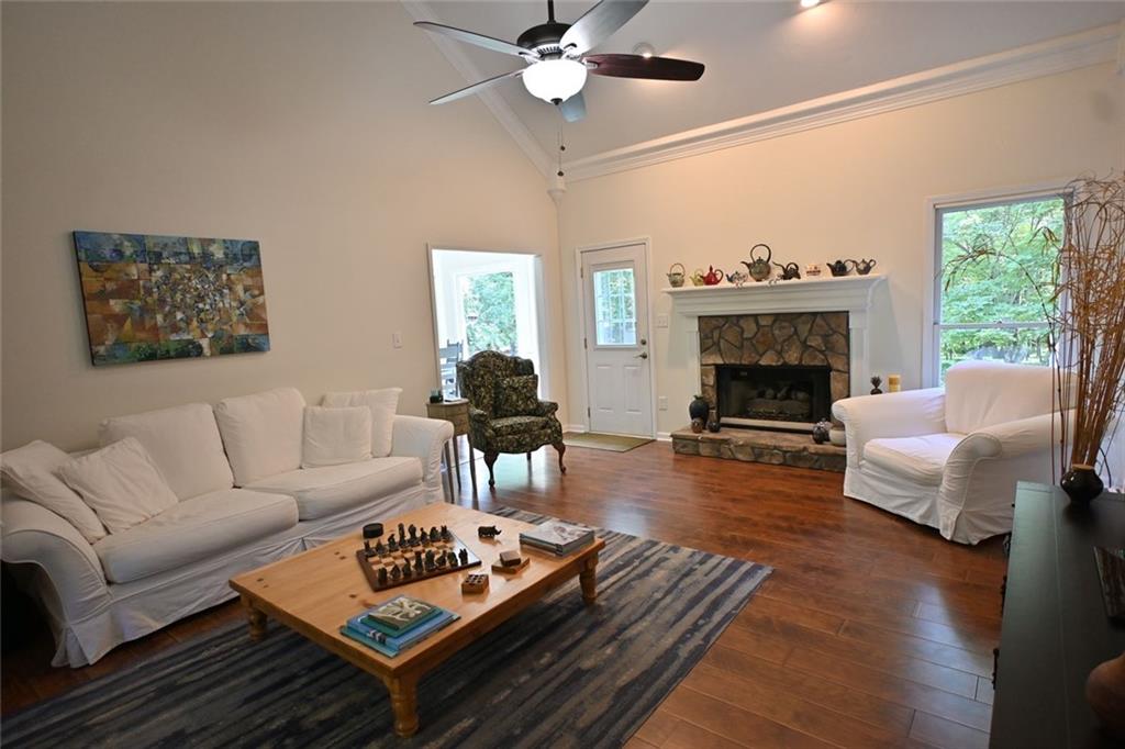 4865 Settles Point Road Suwanee, GA 30024 - Photo 3 of 25 a living room with furniture and a fireplace