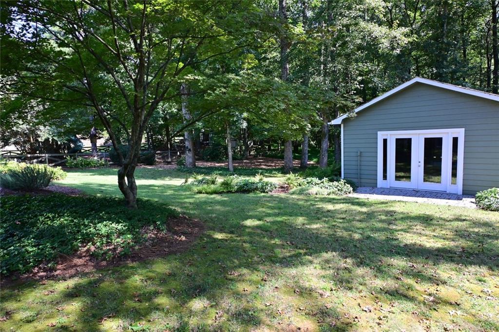 4865 Settles Point Road Suwanee, GA 30024 - Photo 5 of 25 a backyard of a house with lots of green space